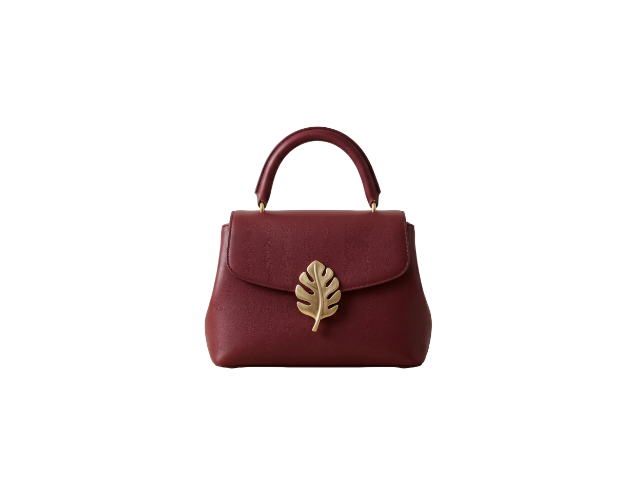 A dark red leather handbag on a white background